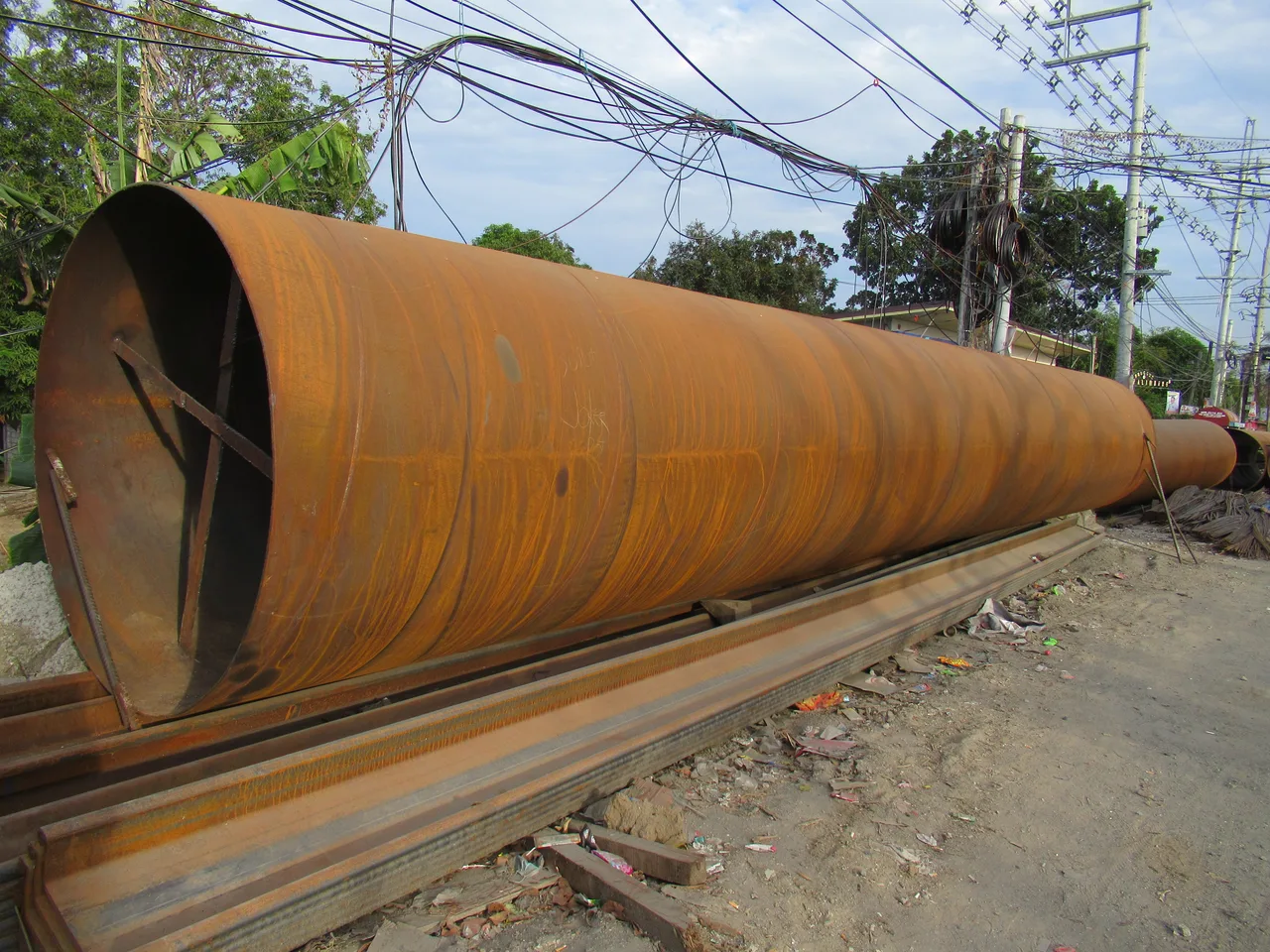 Stacked steel pipes at a supplier stockyard ready for export