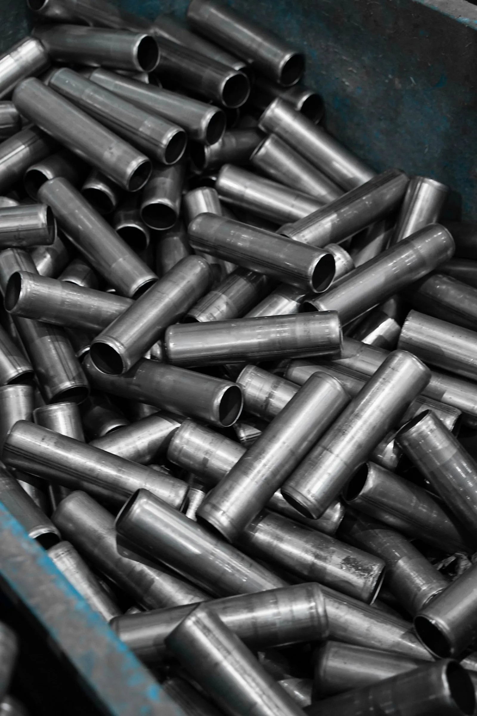 Container of short stainless steel pipes with milled ends stacked for shipment
