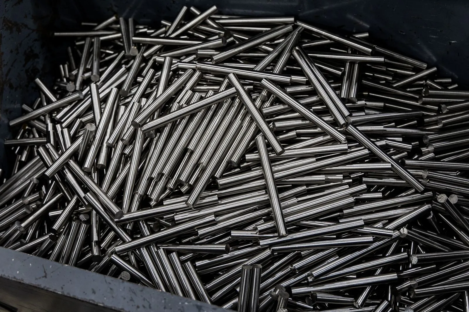 Vertical shot of stainless steel pipes stacked in an industrial container