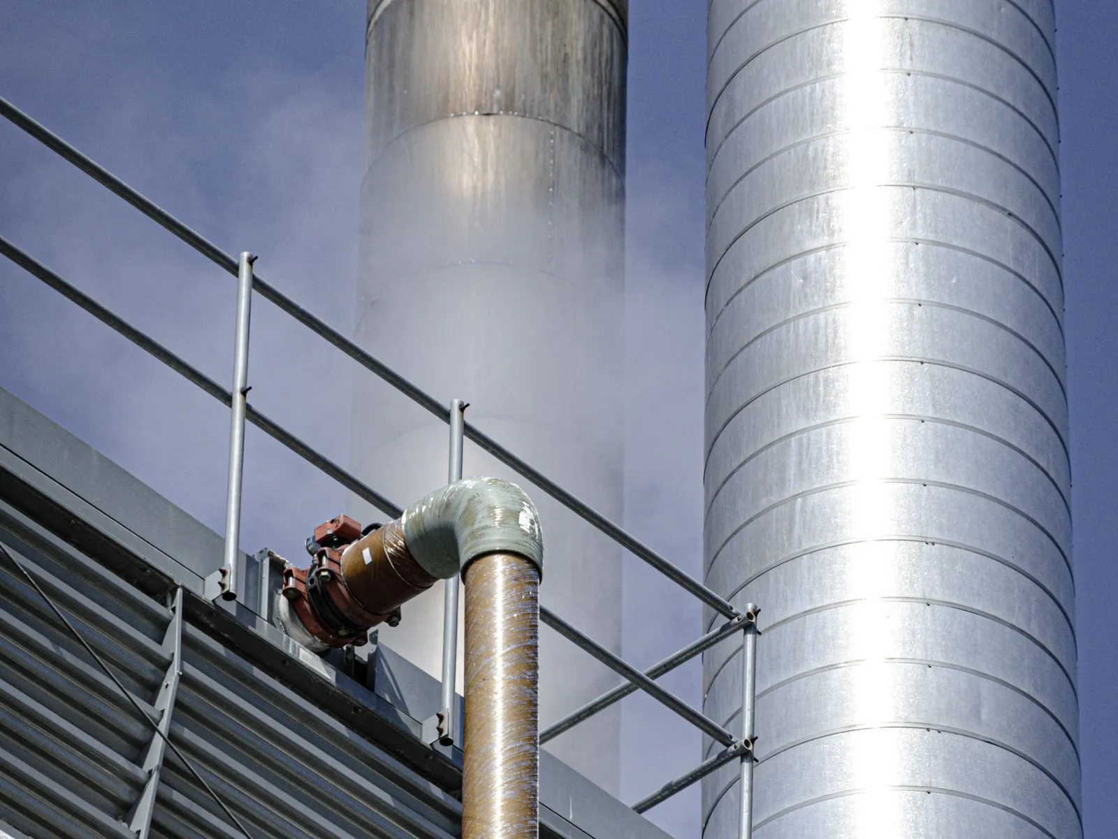 Engineers reviewing steel pipe specification documents on site